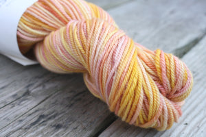 Woodland Merino Wool in Grapefruit Sorbet, yellow pink and purple hand painted yarn