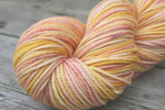 Woodland Merino Wool in Grapefruit Sorbet, yellow pink and purple hand painted yarn